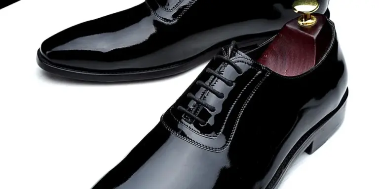 Two polished black leather dress shoes with laces, shown at an angle.