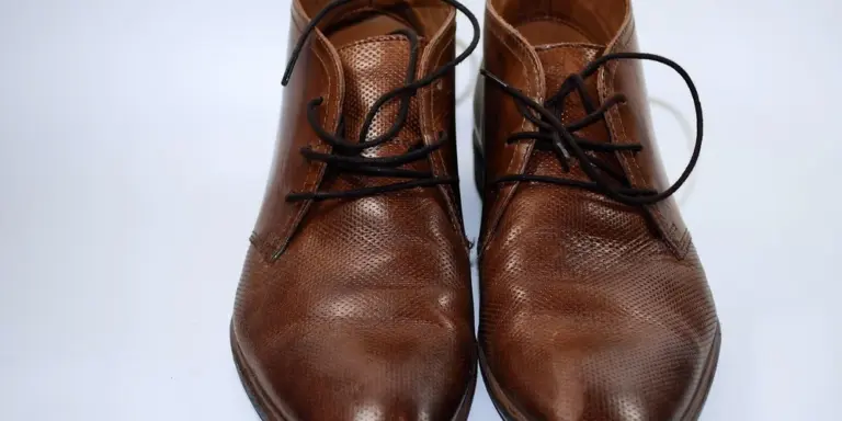Pair of brown leather lace-up dress shoes photographed from above