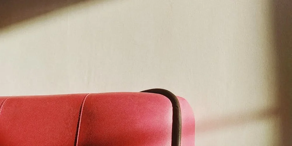 Close-up of red leather with visible grain and stitching