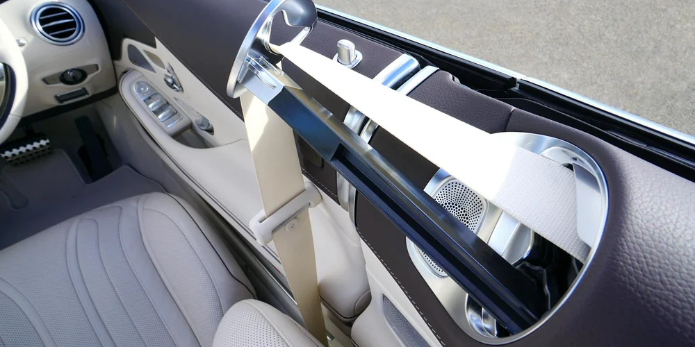 Interior of a car with light tan leather seats and a modern dashboard.