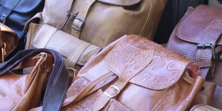 Assorted vintage leather bags in brown tones with worn patina and brass hardware