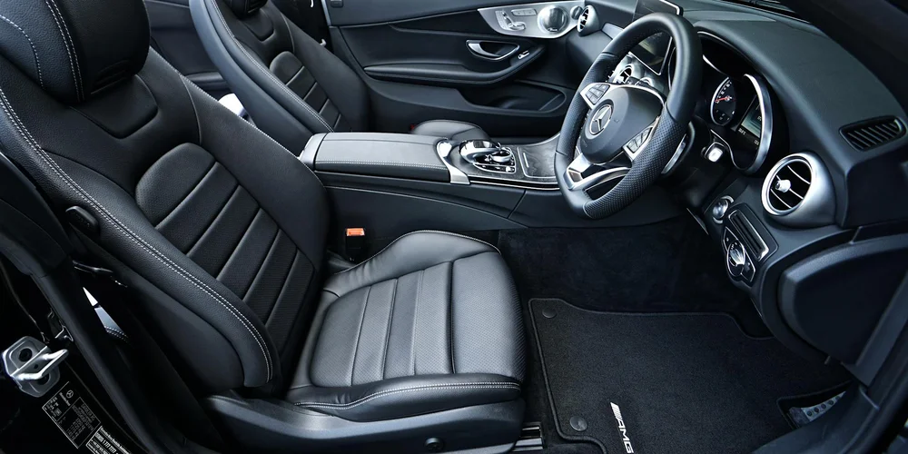 Black leather car seats in a modern, well-appointed vehicle interior
