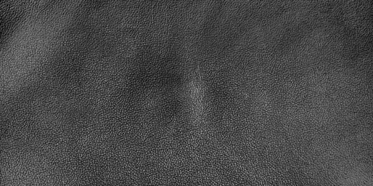Close-up of dark leather upholstery texture