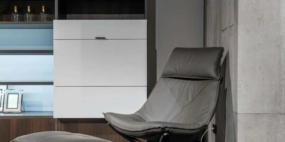 Grey leather chair in a modern living space, illustrating leather furniture.