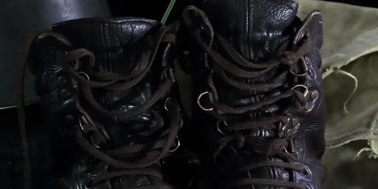 Two dark leather boots with laces, viewed from above.