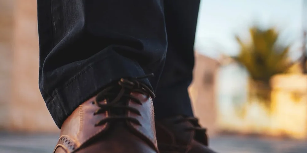 Close-up of a brown leather boot showing texture and stitching.