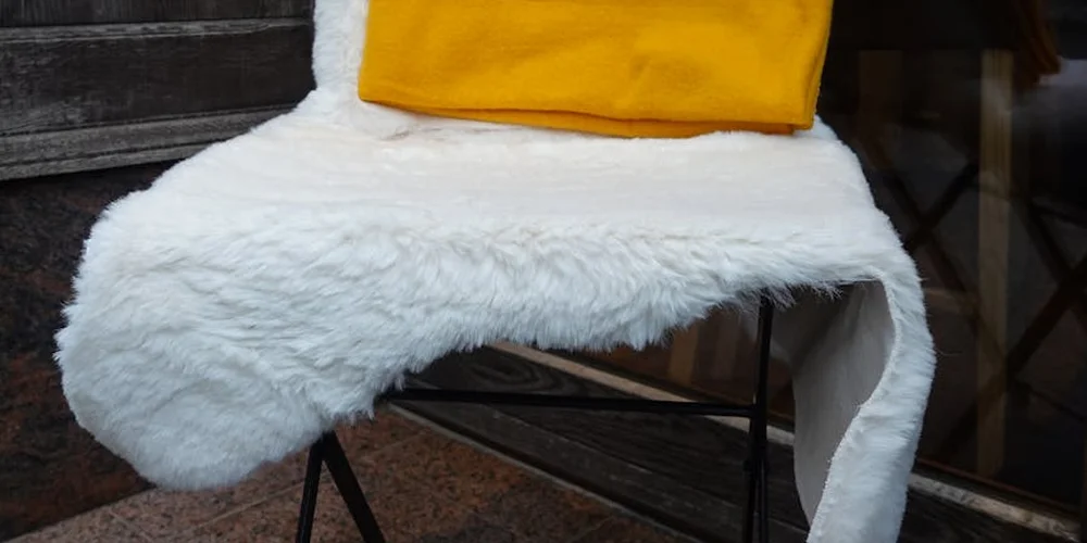 White fluffy medical sheepskin draped over a chair