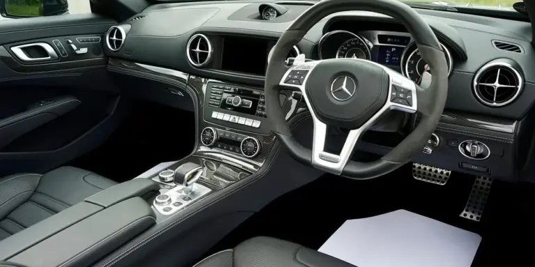 Interior view of a luxury car with black leather seats and a steering wheel