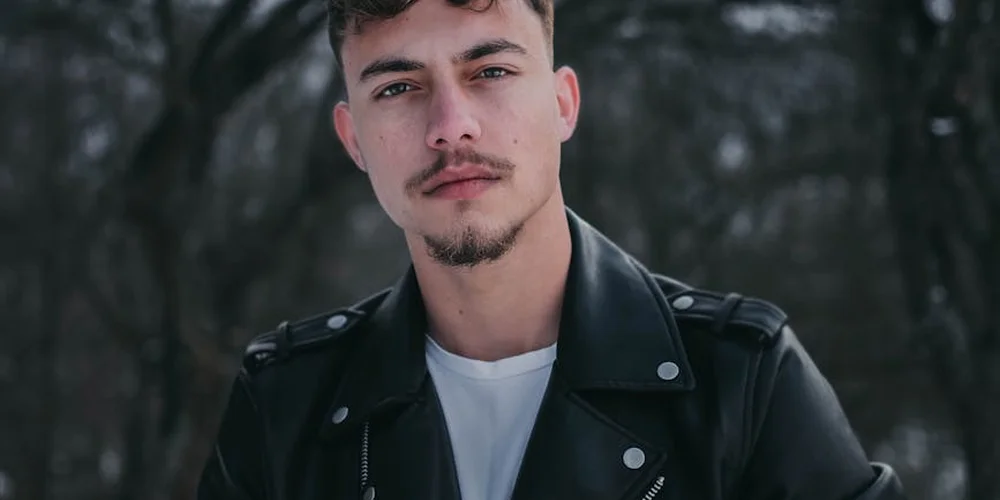 Portrait of a person wearing a black leather jacket outdoors