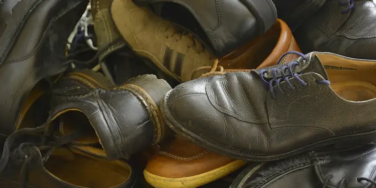 Assorted nubuck and leather shoes and boots piled together