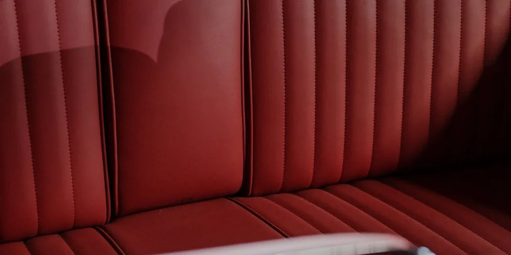 Red leather car seat with vertical stitching panels