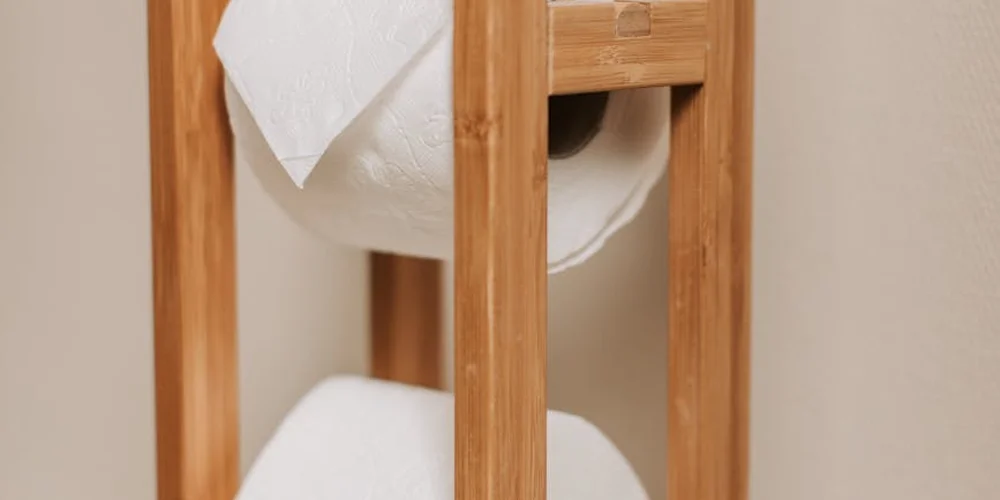 White tissue paper sheets draped and stored on a wooden stand.