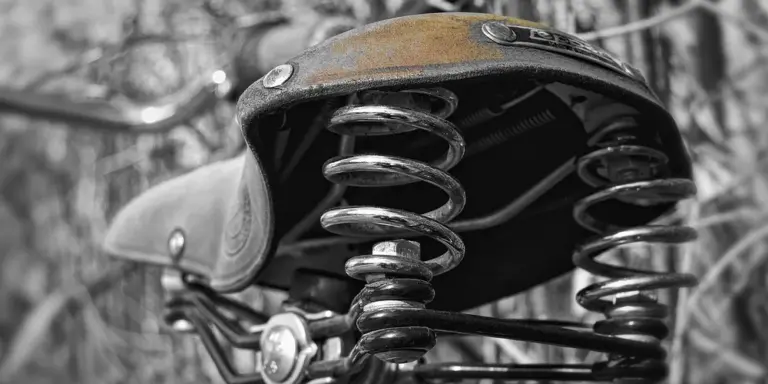 Close-up of a leather saddle seat with visible springs