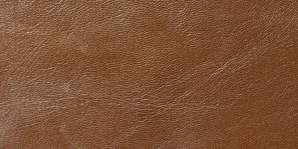 Close-up of a brown sheepskin hide showing its natural grainy texture