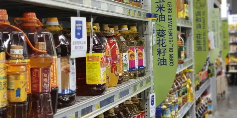 Assorted bottles of oil on supermarket shelves, suggesting leather care products