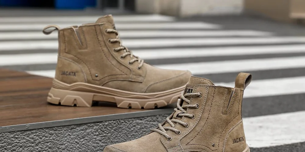 Tan suede boots drying on a ledge near a crosswalk, illustrating the drying step after cleaning to restore the nap of suede.