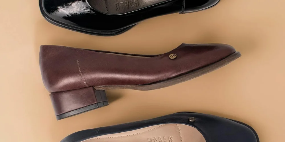Brown suede pump and other shoes on a beige background