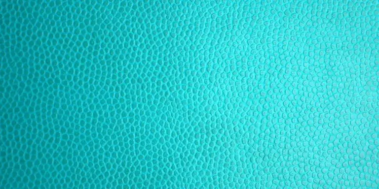 Close-up of turquoise PU leather texture with fine pebble grain
